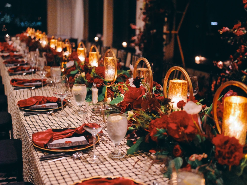 Romantic candlelit wedding table with floral centerpieces – event rentals in Houston