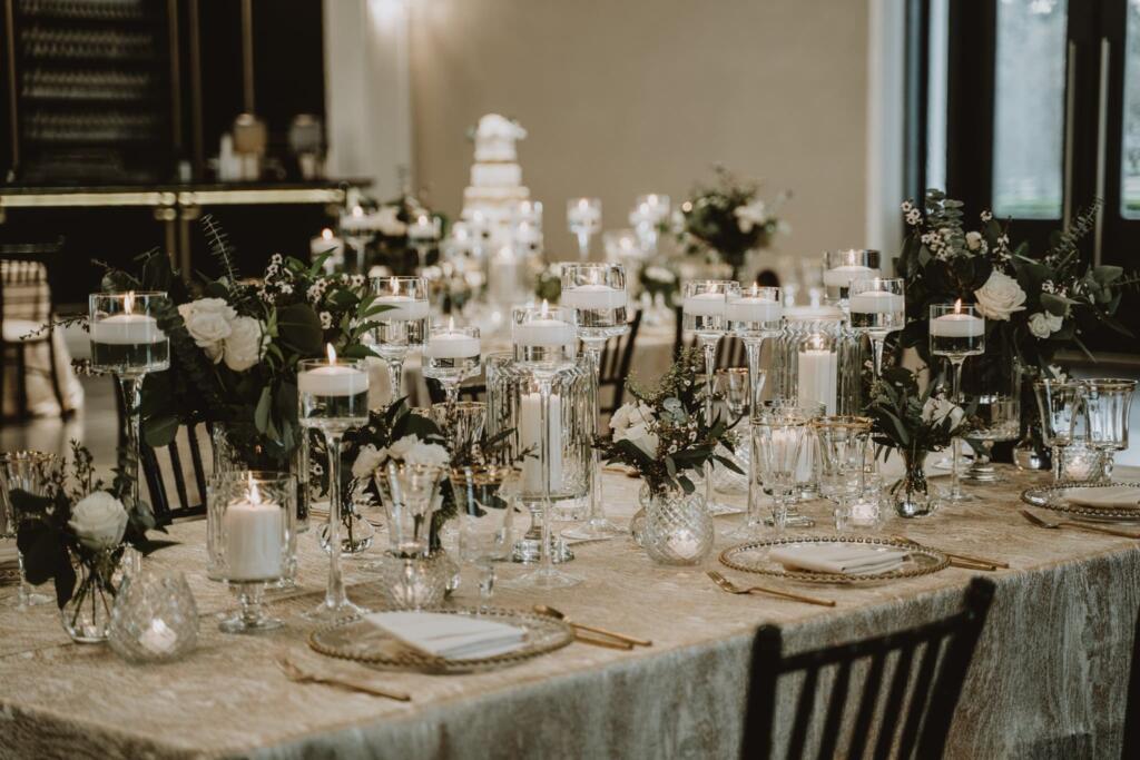 Luxury wedding decorators in Texas – EB Inc Events elegant reception table with floral centerpieces, candles, and gold accents