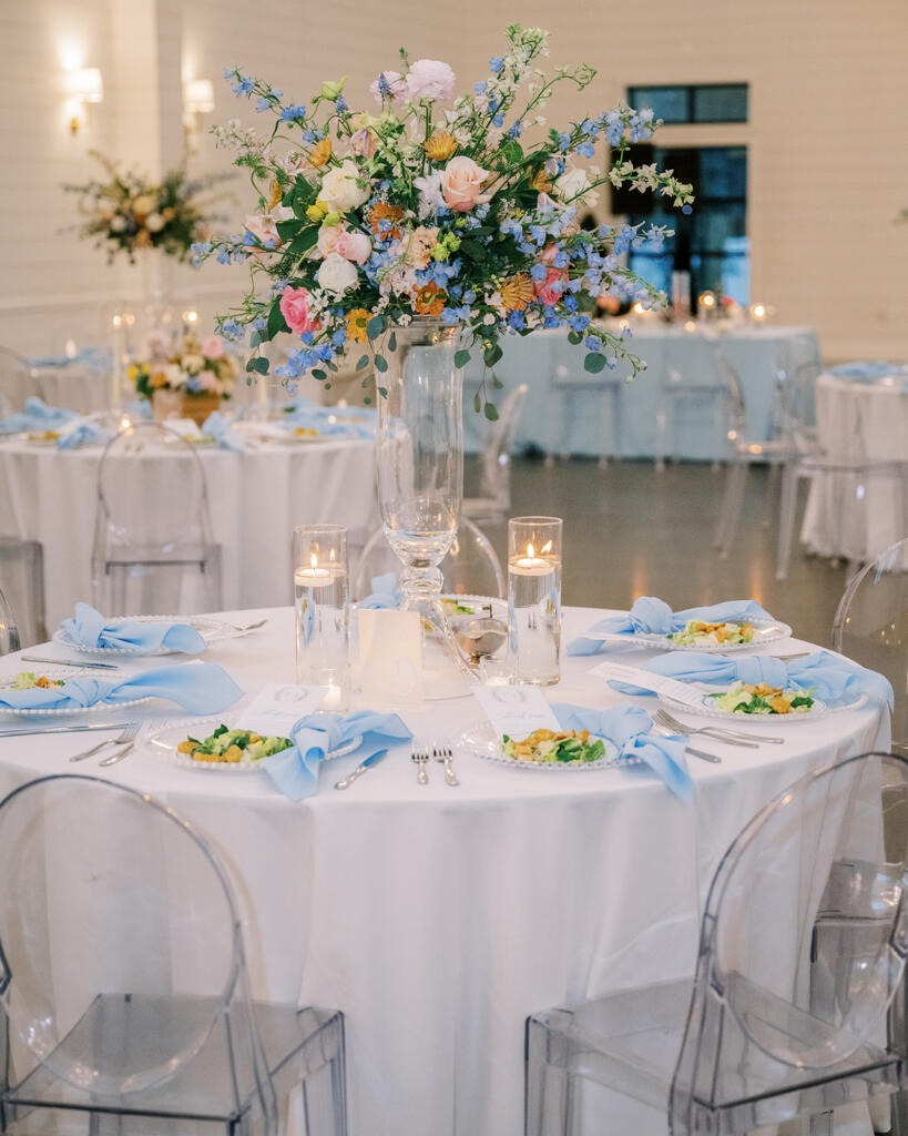 Event table styling Houston wedding round dining table with floral centerpiece and ghost chairs
