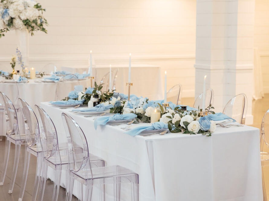 Event table styling Houston wedding reception with layered white linens and floral centerpieces