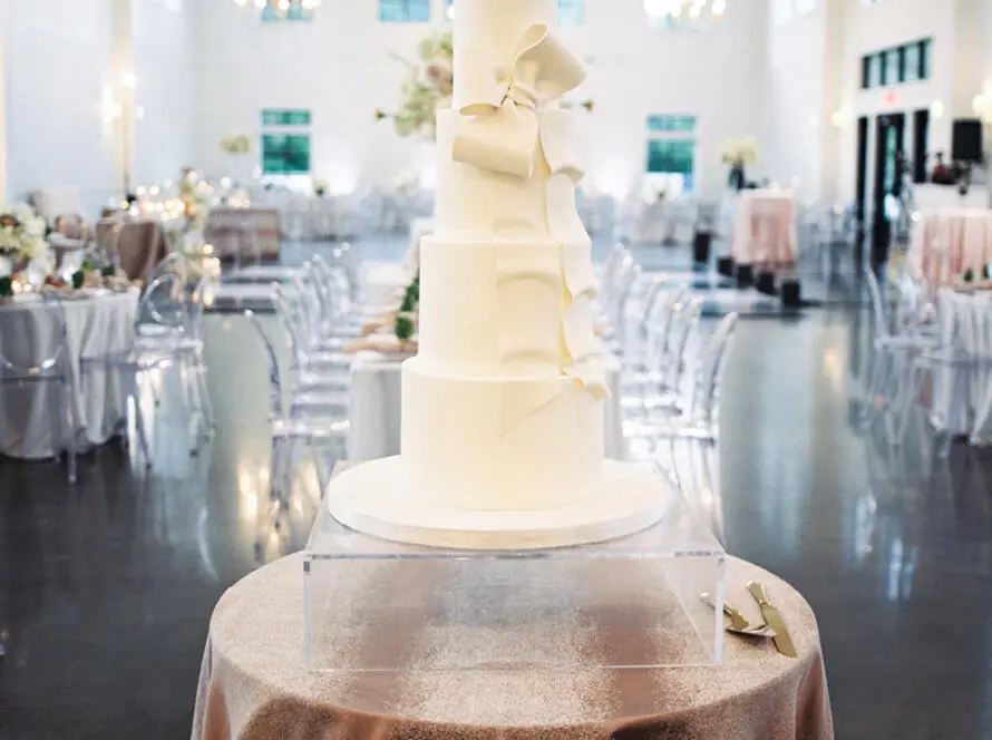 Elegant wedding cake table setup from The Brawner Wedding at EB Inc Events – table and chair rentals near me in Houston