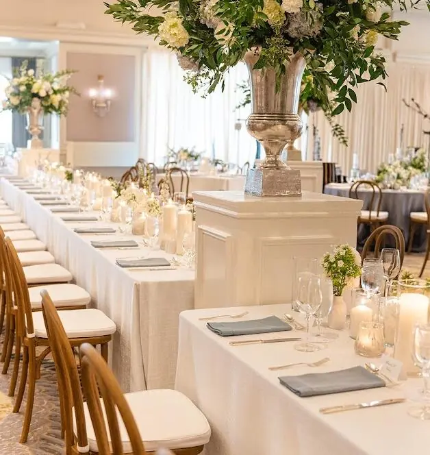 Houston wedding color palette with ivory linens, white florals, and greenery at a ballroom reception