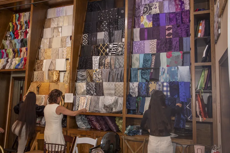 Women browsing linen inventory shelves in EB Inc's warehouse – photo by Pixel Studio Productions