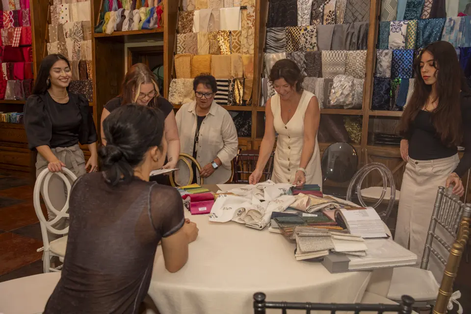 EB Inc staff organizing wedding linen swatches in the Houston showroom