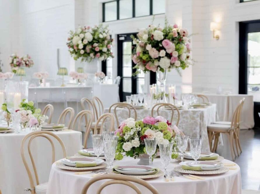 Elegant wedding decor rentals Houston setup with pink linens, floral centerpieces, and stylish reception table design.