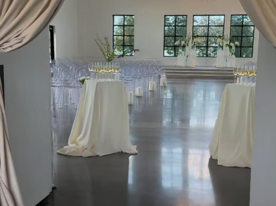 Event rental setup and breakdown for a formal ceremony space with draping and seating