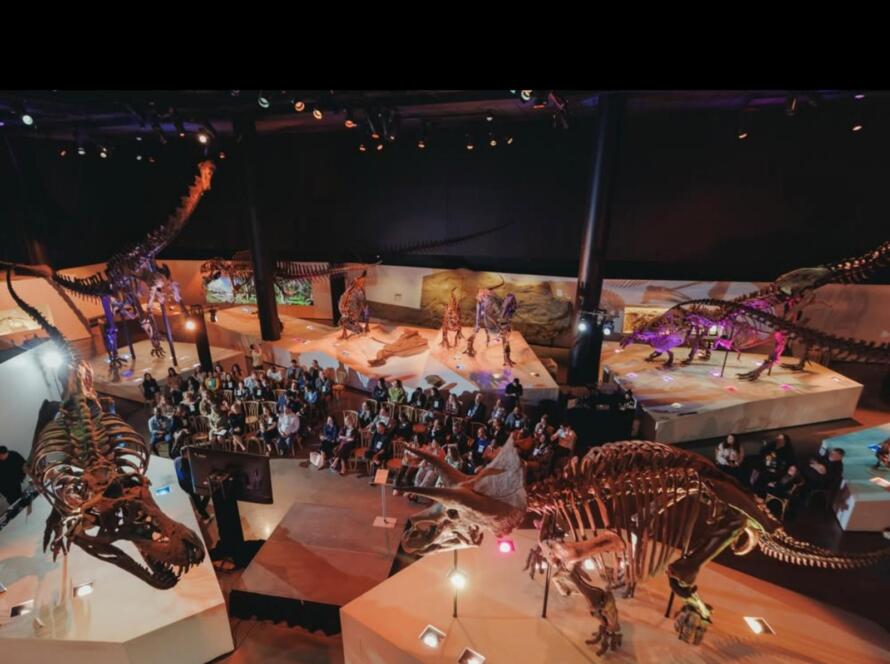Houston corporate event vendors managing a large conference setup inside a museum venue with staged seating and lighting