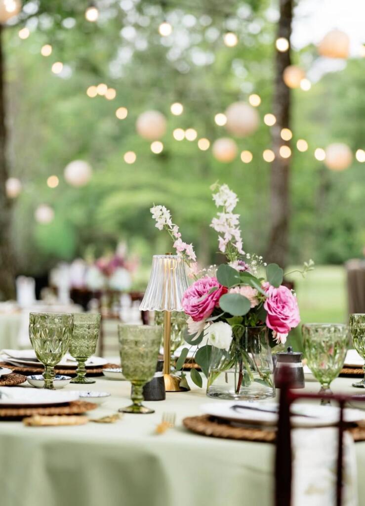 Houston event rentals outdoor table setup with lighting and floral centerpieces