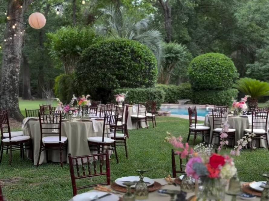 Houston event rentals outdoor wedding setup with tables, chairs, and lighting
