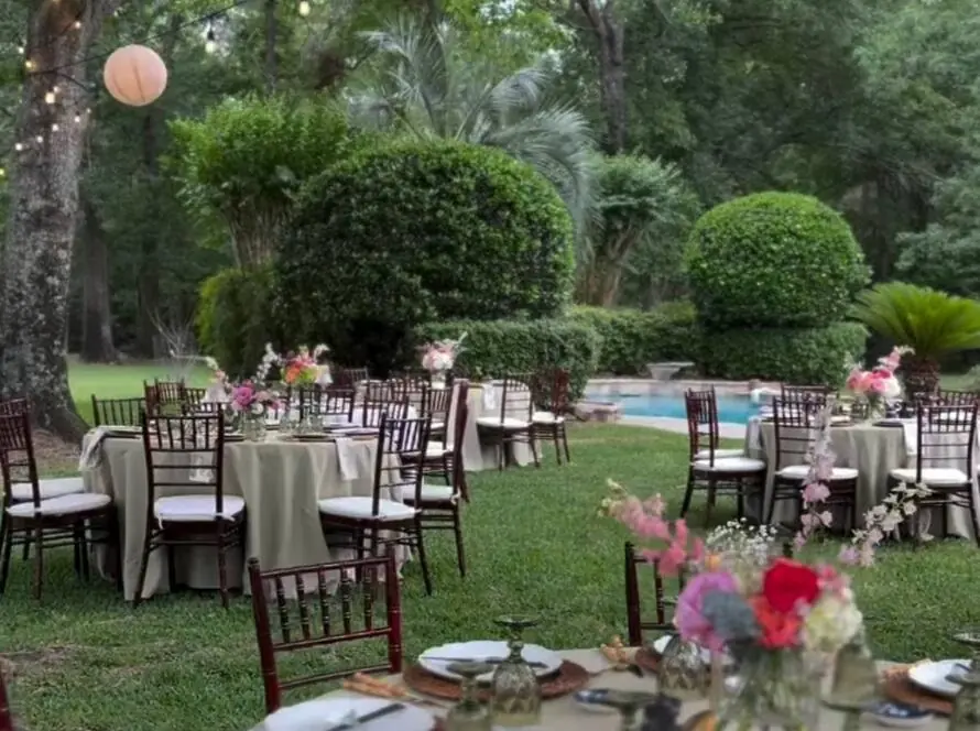 Houston event rentals outdoor wedding setup with tables, chairs, and lighting