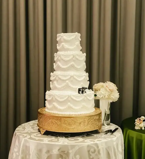 Backdrop rental Houston wedding cake display with draping behind