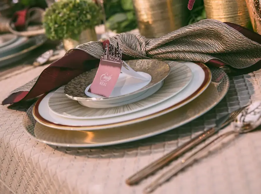 Charger plate rental Houston place setting with hammered gold charger, white china, and blush textured linen